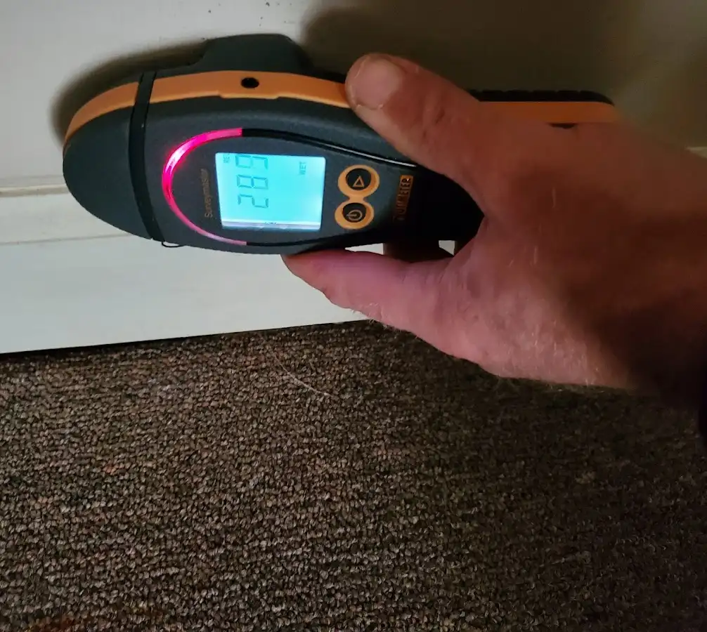 Moisture detection at baseboard during Storm Damage Restoration in Fuquay